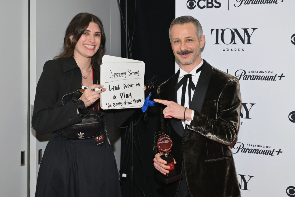 Jeremy Strong holds up his Tony Award or Best Actor in a Play