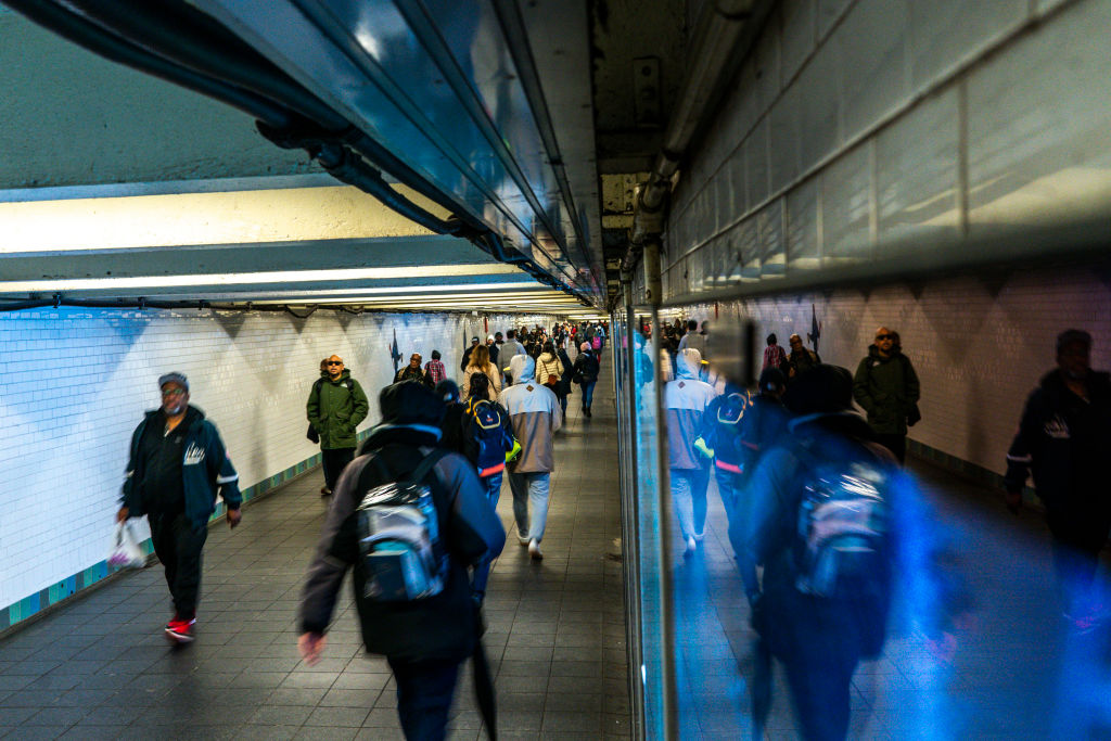 Commuters walk through a tunnel at the Times Square-42nd Street subway station on March 6, 2024.