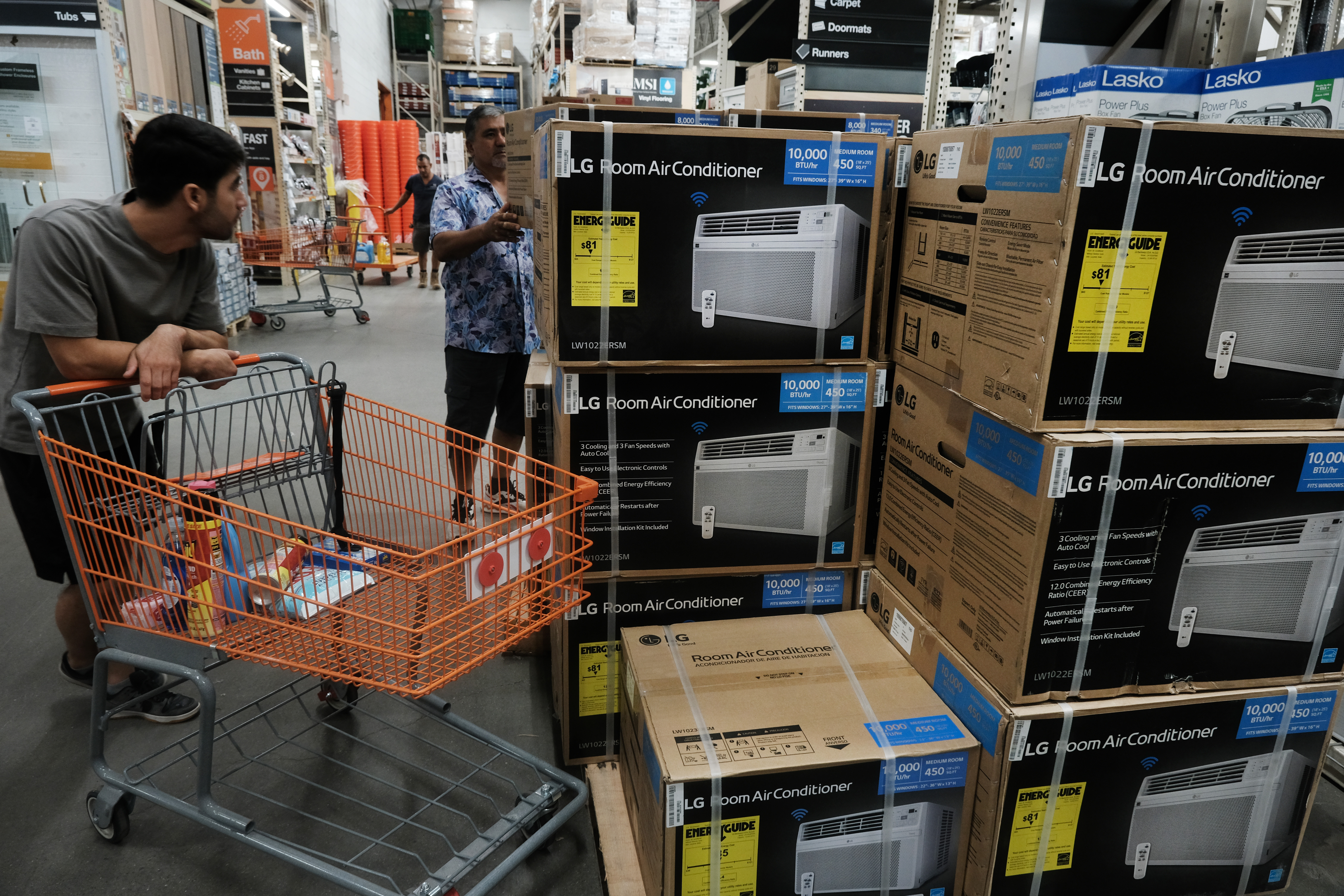 Men purchase an air conditioner at a Home Depot during a heat wave in Brooklyn during a heat wave last year.