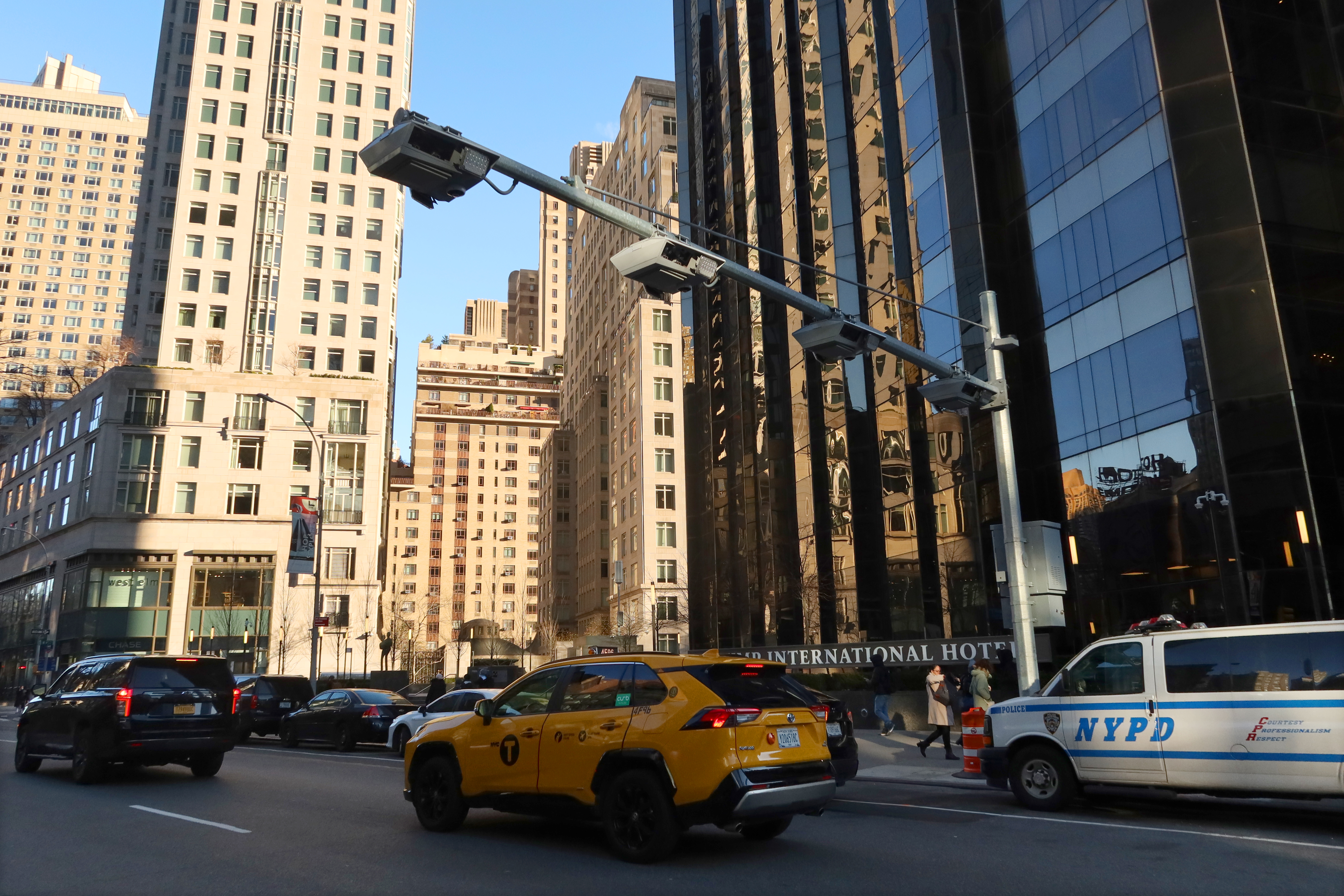 A taxicab drives down a busy street in New York City.