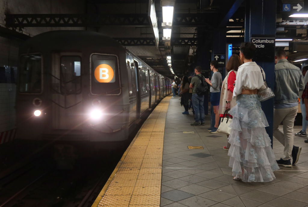 New York City subway riders wait as a B train arrives at the 59th Street-Columbus Circle station in Manhattan on May 29, 2024.