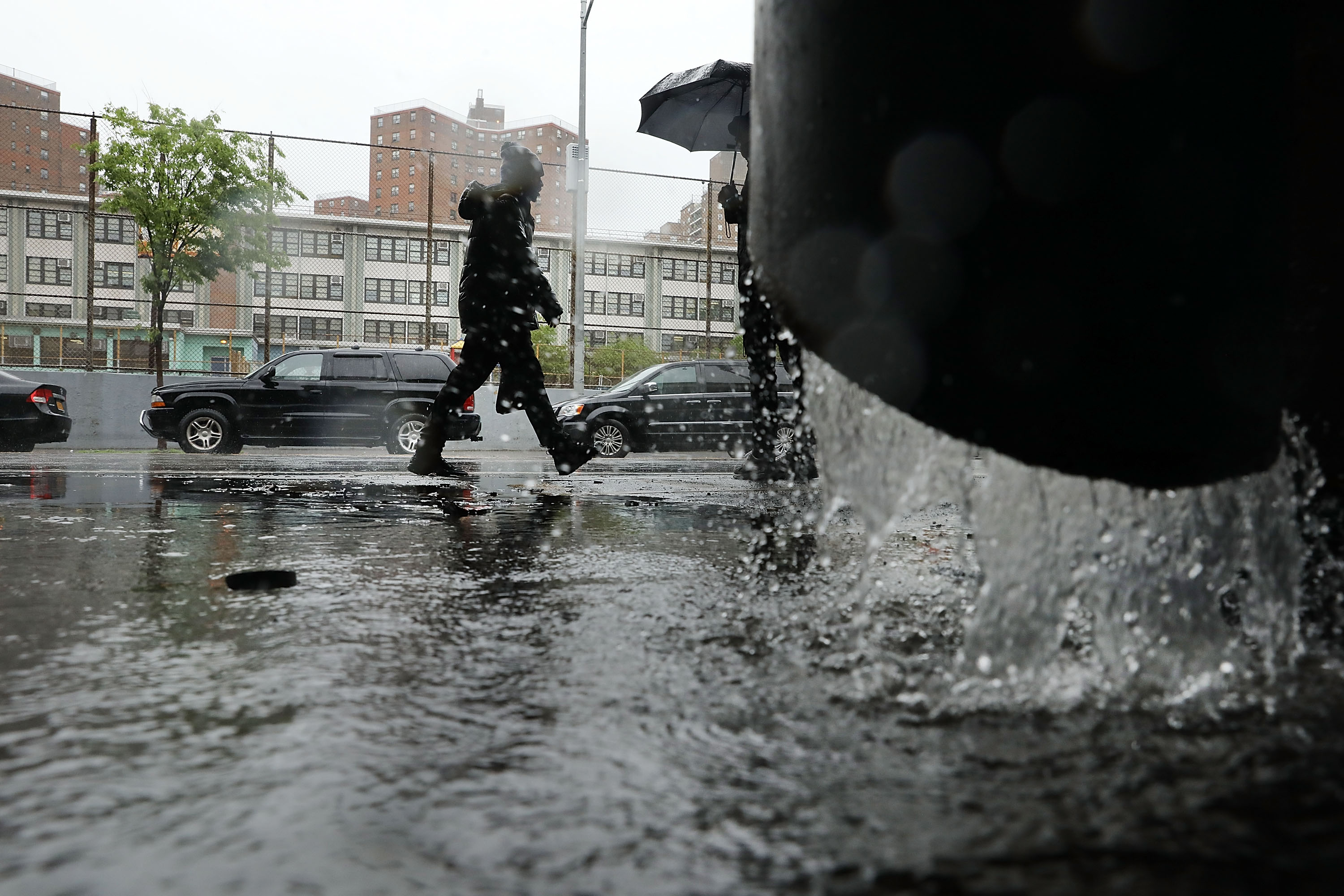 A man walking in Manhattan passed a water spout.