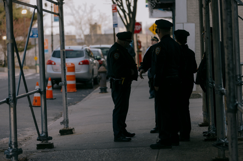 Officers convene under a scaffolding.