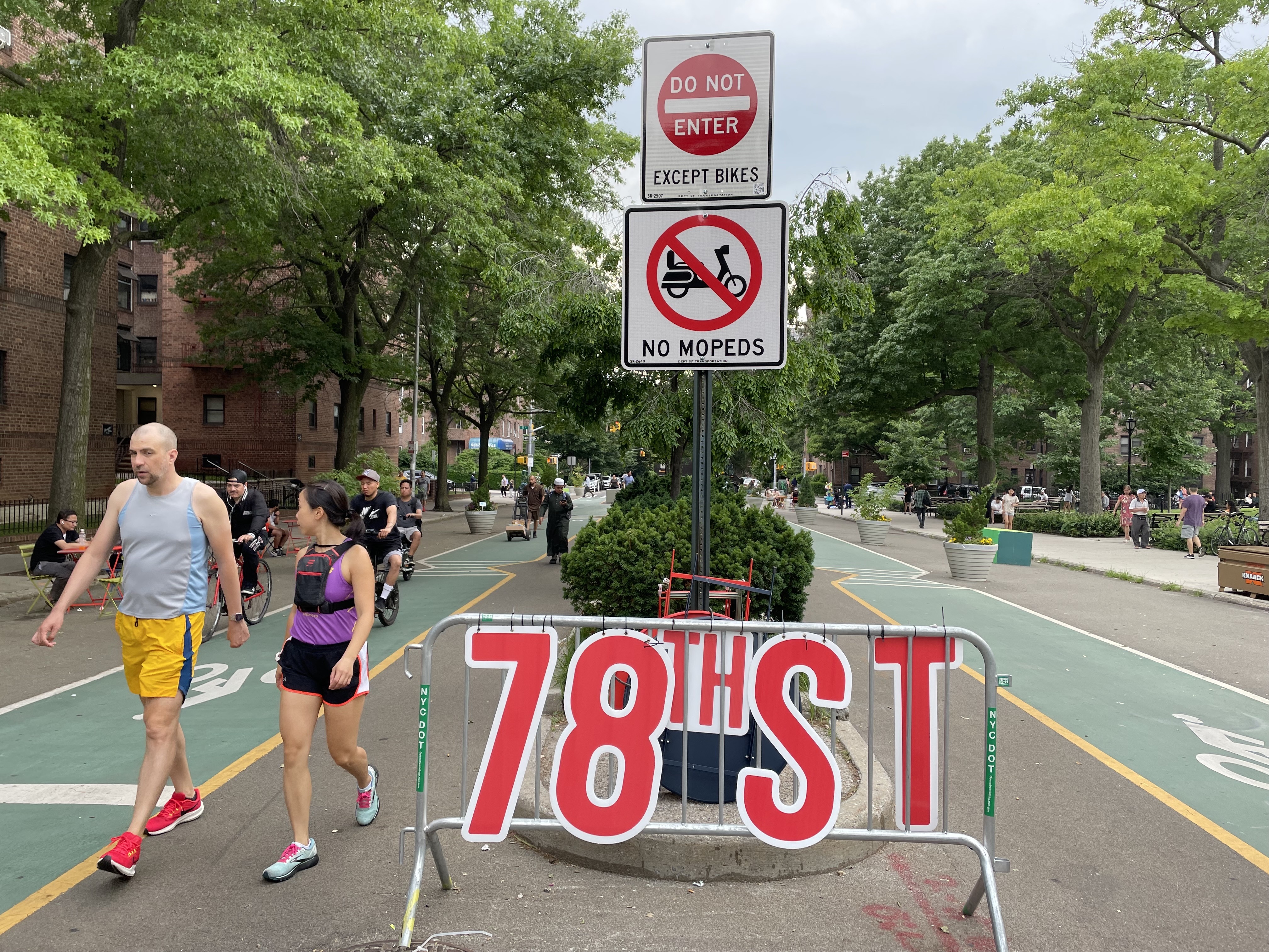 Pedestrians, e-bikes and other two-wheeled, motorized vehicles share the 26-block open street on 34th Avenue in Jackson Heights, Queens. Many local residents complain the conditions are unsafe.