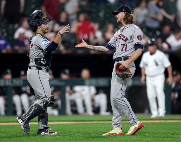 Houston Astros catcher César Salazar (18) and relief pitcher Josh Hader (71) celebrate a victory after closing out the Chicago White Sox in the ninth inning of a game at Guaranteed Rate Field in Chicago on June 19, 2024. (Chris Sweda/Chicago Tribune)