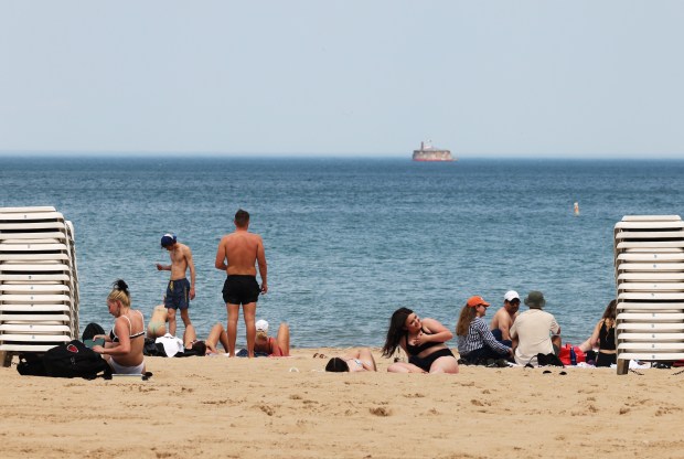 Beachgoers spend part of their afternoon at Oak Street Beach on May 21, 2024, in Chicago. (John J. Kim/Chicago Tribune)