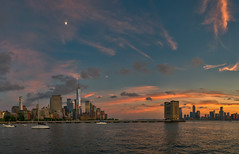 Sunset clouds and the moon over Lower Manhattan and Jersey City as seen from Pier 40