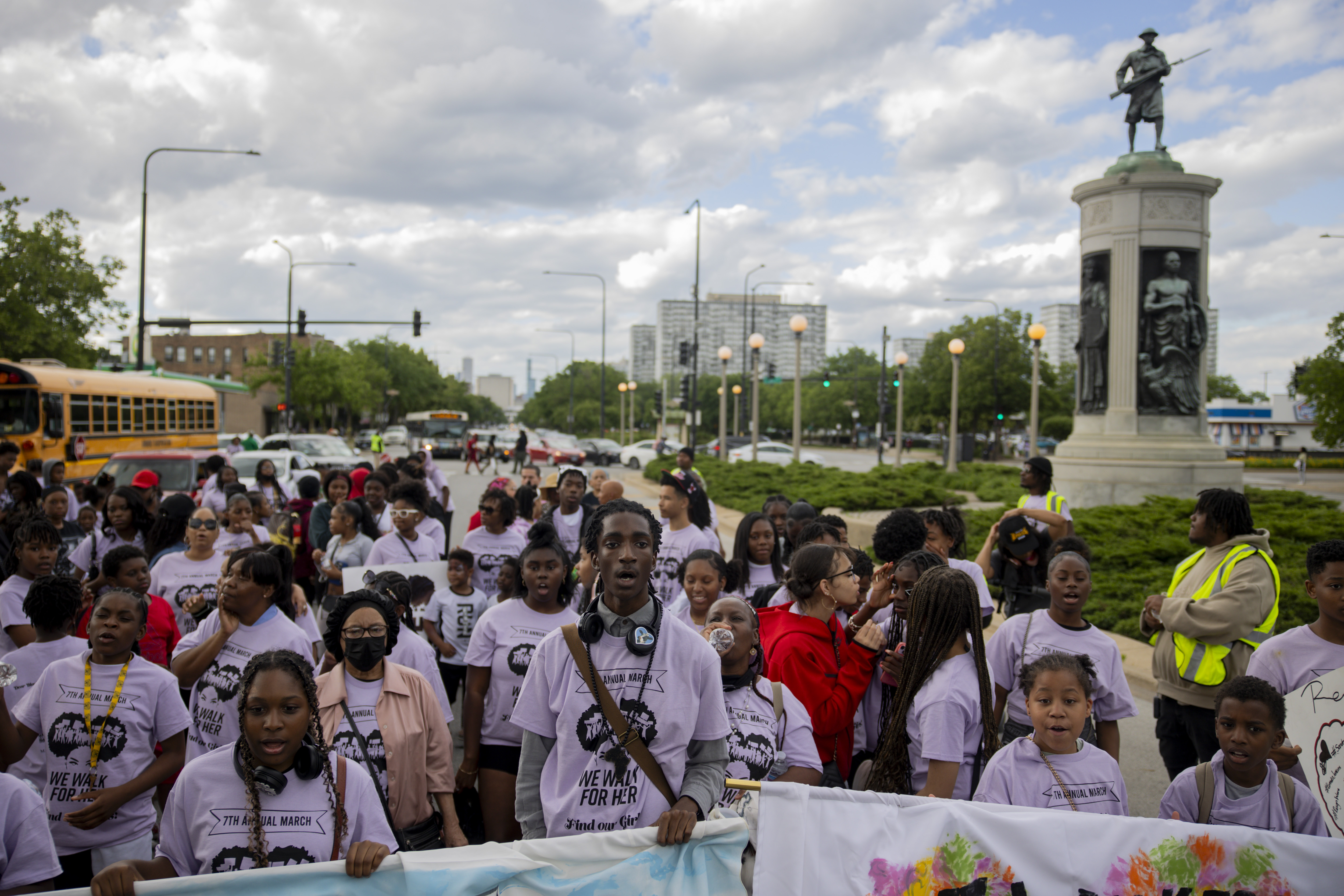 Community members and activists, including Sekou Kenyatta, center, line up...