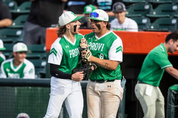 Providence's Cooper Eggert and Enzo Infelise (9) celebrate after getting out of a bases-loaded jam against Edwardsville in the sixth inning of the Class 4A state semifinals at Duly Health and Care Field in Joliet on Friday, June 7, 2024. (Vincent D. Johnson/for the Daily Southtown)